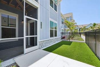 A modern house with a white door and a black fence. at The Junction at Rockledge Apartments, Rockledge, Florida